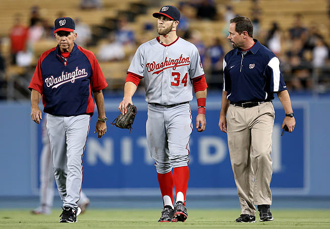 Bryce Harper walked off the field on his own after slamming into the outfield fence and cutting his chin.